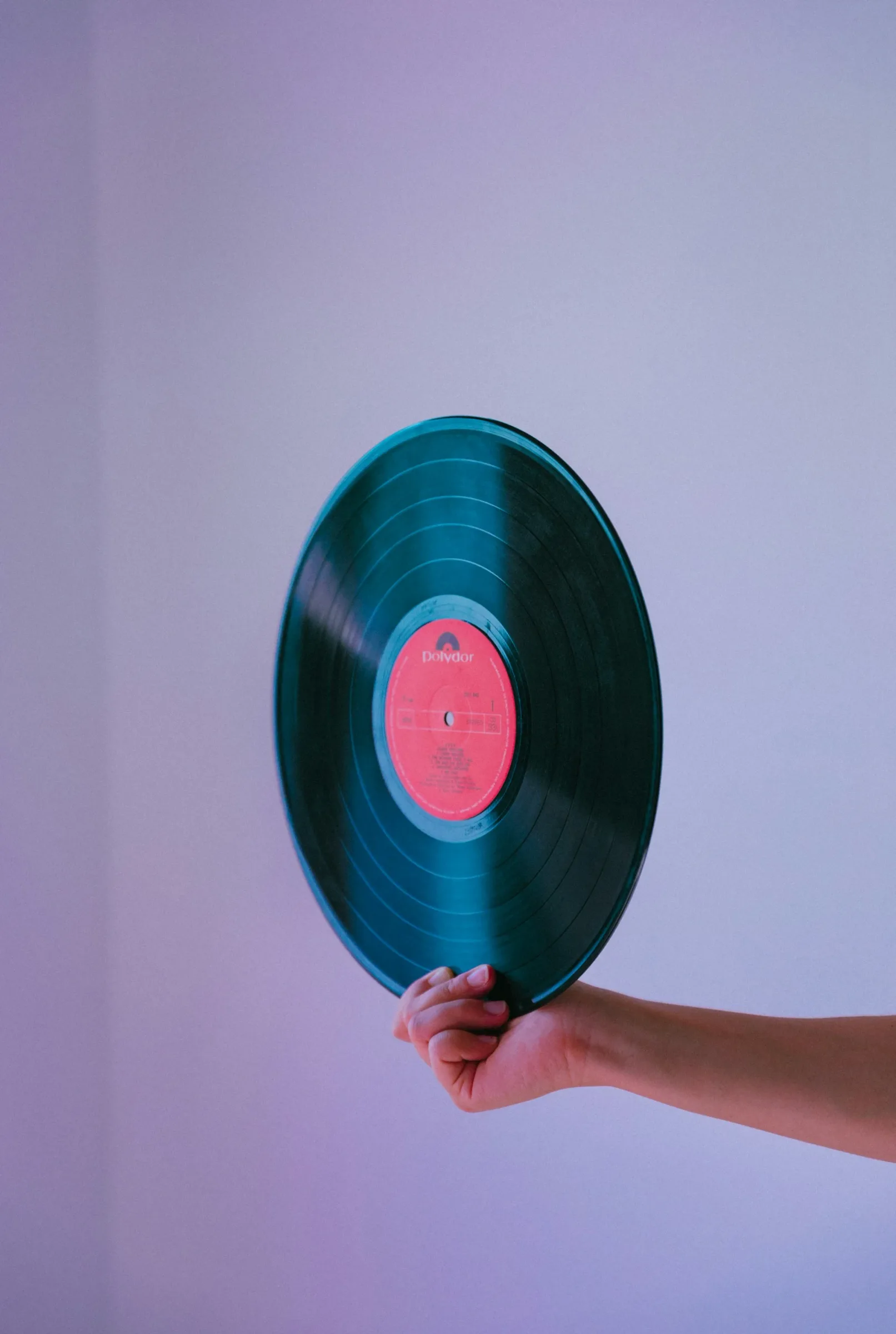 Shopper crouched at a vinyl bin, absorbed in flipping through records at a record store