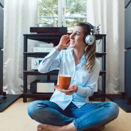 Woman in headphones enjoying a record at home