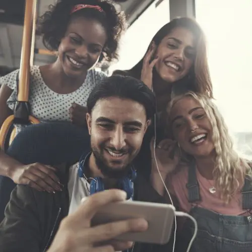 Friends listening to music together and smiling